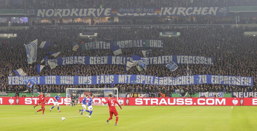 epa08267738 Schalke 04 fans display banners during the German DFB Cup quarter final match between Schalke 04 and Bayern Munich in Gelsenkirchen, 03 March 2020. EPA/FRIEDEMANN VOGEL CONDITIONS - ATTENT ...