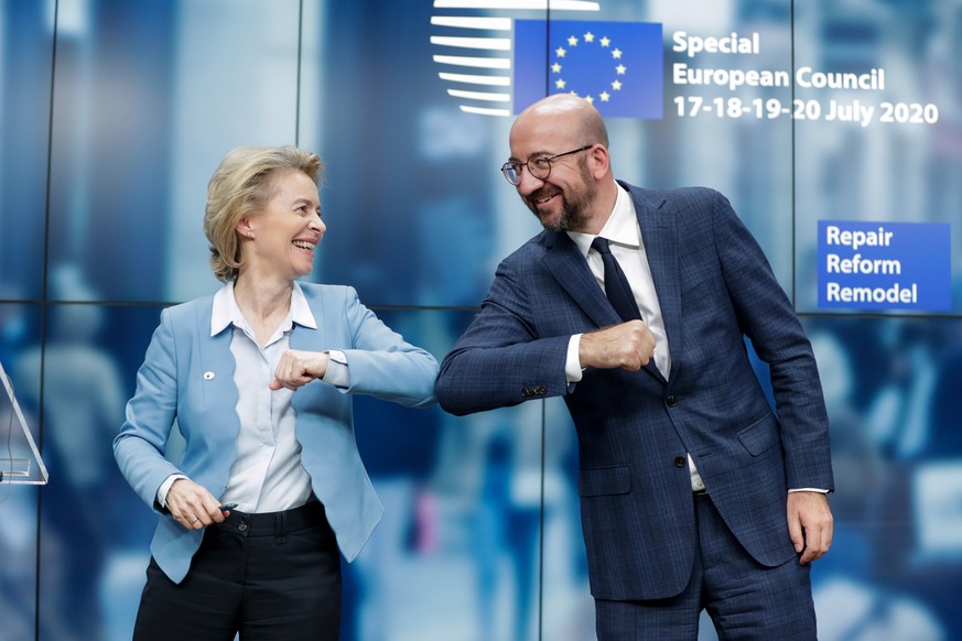 epaselect epa08557681 European Commission President Ursula Von Der Leyen (L) and European Council President Charles Michel (R) give a elbow shot at the end of a news conference following a four day Eu ...