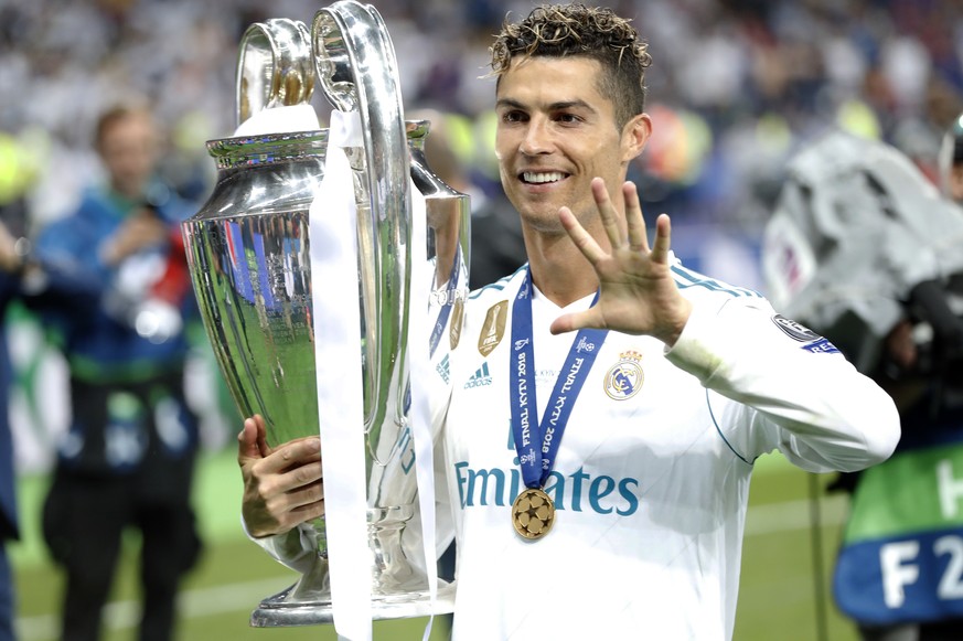 Real Madrid&#039;s Cristiano Ronaldo celebrates with the trophy after winning the Champions League Final soccer match between Real Madrid and Liverpool at the Olimpiyskiy Stadium in Kiev, Ukraine, Sat ...