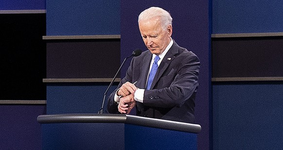 epaselect epa08766923 Democratic candidate Joe Biden checks his watch as he debates US President Donald J. Trump during the final presidential debate in the Curb Event Center at Belmont University in  ...