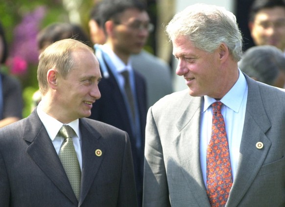 FILE - In this July 21, 2000 file photo, President Bill Clinton shares a light moment with Russian President Vladimir Putin before a Group of Eight meeting in Nago, Okinawa, Japan. In a series of inte ...