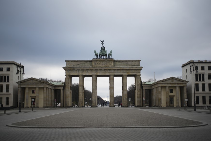 The Pariser Platz square in front of the German landmark Brandenburg Gate is deserted in Berlin, Germany, Monday, March 30, 2020. In order to slow down the spread of the coronavirus, the German govern ...