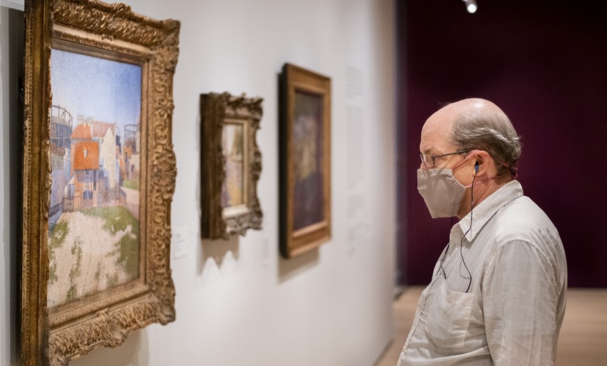 epa08630200 A person looks at works of art at Museum of Modern Art on the first day that the museum is reopening to the public in New York, New York, USA, 27 August 2020. MoMA, along with other museum ...