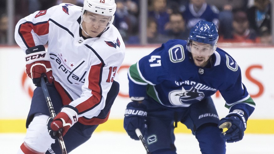 Washington Capitals&#039; Jakub Vrana, front left, of the Czech Republic, skates with the puck while being watched by Vancouver Canucks&#039; Sven Baertschi, of Switzerland, during the first period of ...