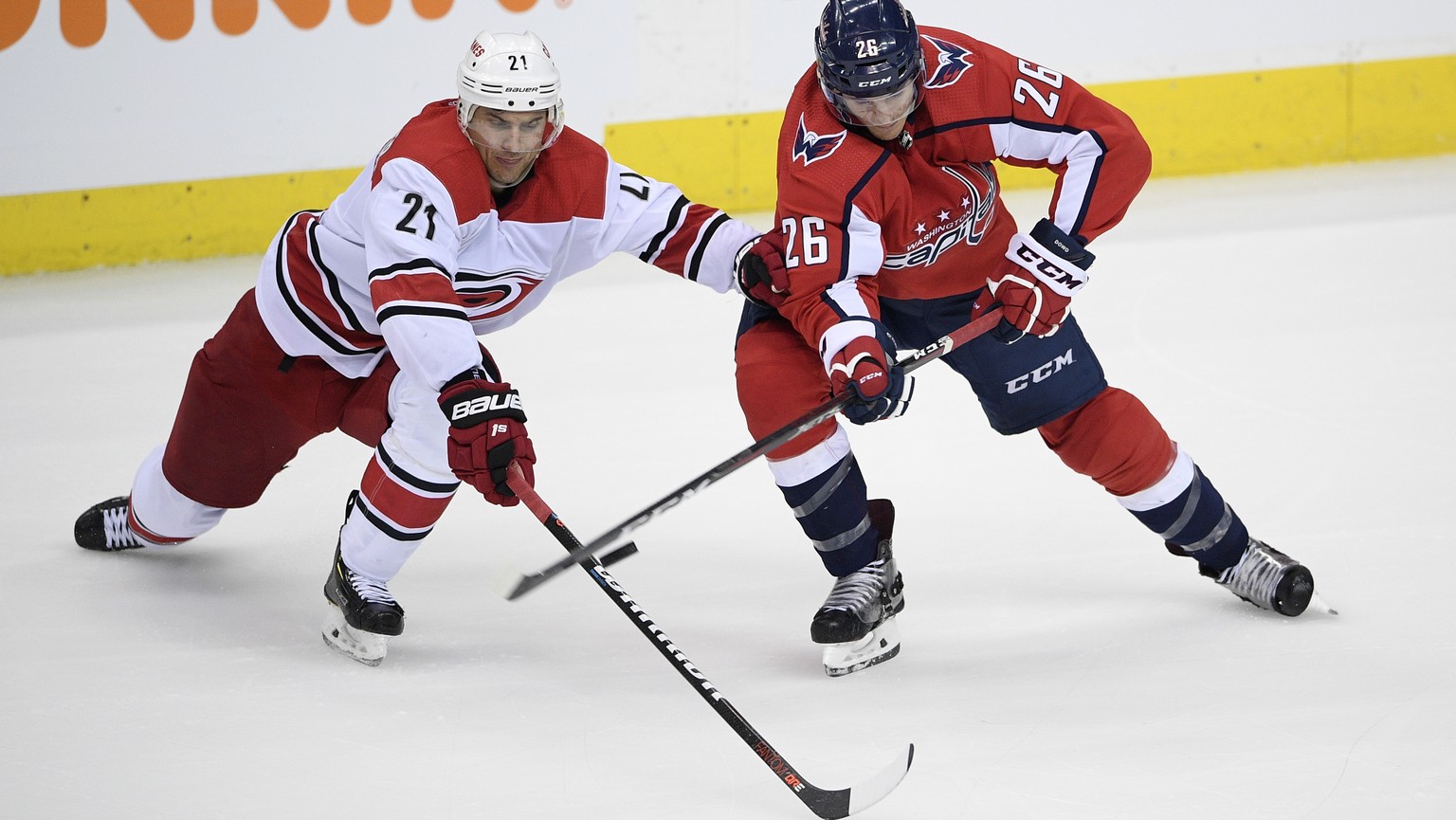 Carolina Hurricanes right wing Nino Niederreiter (21) works for the puck against Washington Capitals center Nic Dowd (26) during the third period of Game 1 of an NHL hockey first-round playoff series  ...