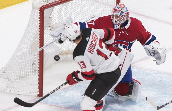 New Jersey Devils&#039; Nico Hischier scores against Montreal Canadiens goaltender Keith Kinkaid during the second period of an NHL hockey game in Montreal, Saturday, Nov. 16, 2019. (Graham Hughes/The ...