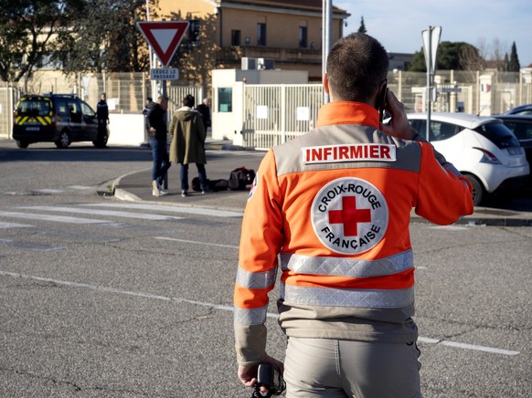 epa08181084 A member of the French Red Cross walks by the entrance of the Istres-Le Tube Air Base near Istres, northwest of Marseille, southern France, 31 January 2020, where French citizens, repatria ...