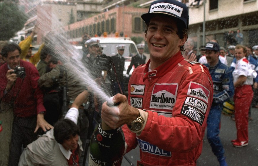 FILE - In this May 12, 1990, file photo, Brazilian driver Ayrton Senna sprays champagne on the photographers to celebrate his career&#039;s 30th victory at the Monaco Formula One Grand Prix May 12, 19 ...