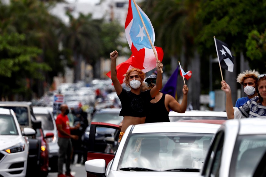 epa08396783 People participate from their cars during a demonstrations for the International Labor Day, in San Juan, Puerto Rico, 01 May 2020. Several demonstrations commemorated this Friday the Inter ...