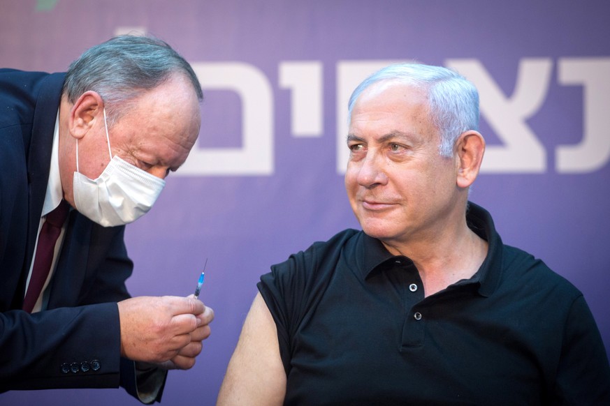 epa08929178 Israeli Prime Minister Minister Benjamin Netanyahu is administered the second jab of the Covid-19 vaccine, at Sheba Medical Center in Ramat Gan, Israel, 09 January 2021. Netanyahu received ...
