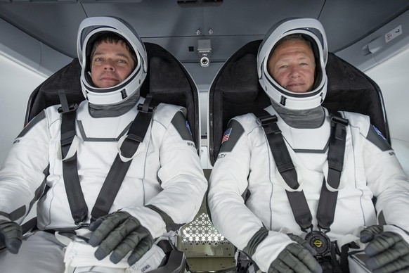 epa08580085 (FILE) - A handout picture made available by SpaceX shows NASA astronauts Bob Behnken (L) and Doug Hurley participating in a fully integrated test of SpaceX Crew Dragon flight hardware at  ...