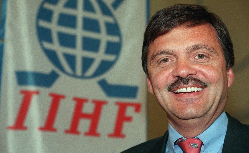 Rene Fasel (48) of Switzerland poses in front of the new flag of the International Ice Hockey Federation (IIHF) during the opening day of the IIHF congress on May 31, 1998, in Lausanne. On Monday, Jun ...