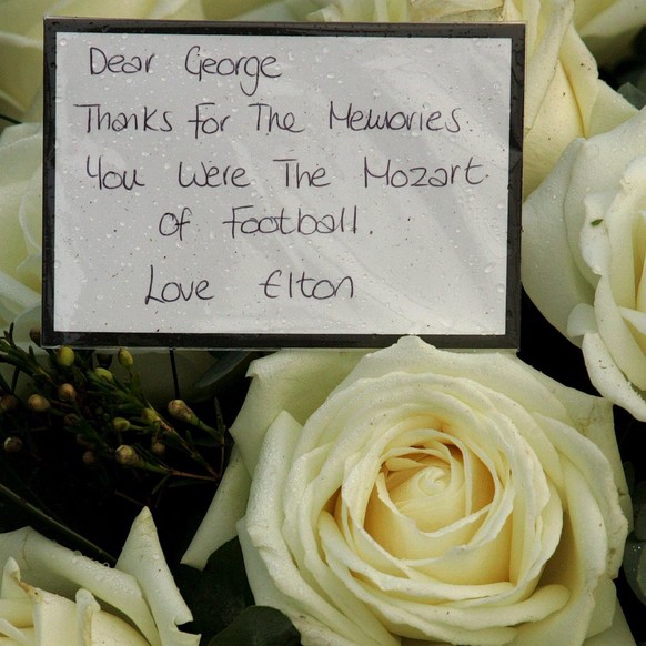 Flowers from Sir Elton John lay close to the grave of George Best at Roselawn Cemetery, east Belfast, Northern Ireland, Sunday, 04 December 2005. George Best&#039;s grave is being kept under 24-hour g ...