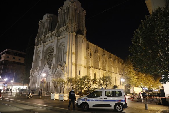 epa08784073 French police officers secure the street near the entrance of the Notre Dame Basilica church in Nice, France, 29 October 2020, following a knife attack. Three people have died in what offi ...