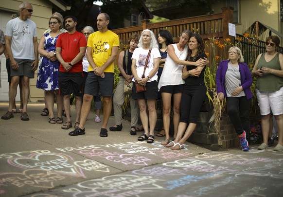 ADDS NAME OF WOMAN KILLED - People listen as Bethany Bradley of Women&#039;s March Minnesota speaks at the beginning of a vigil to remember Justine Damond, from Sydney, Australia, who was shot and kil ...