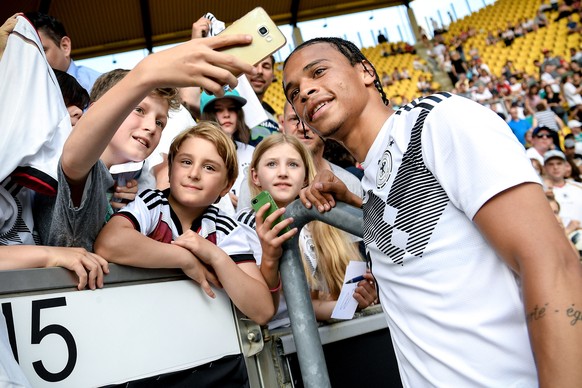 epa07628156 Germany&#039;s Leroy Sane (R) poses for selfies with fans after a training session in Aachen, Germany, 05 June 2019. Germany prepares the UEFA EURO 2020 qualifiyng soccer matches against B ...