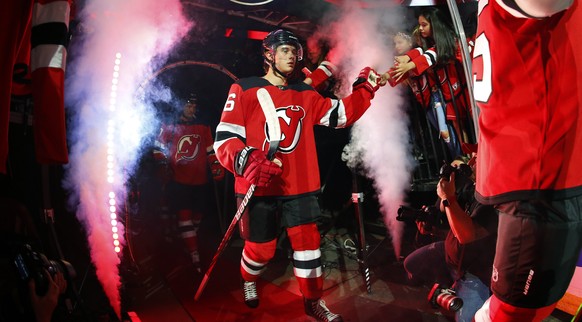 New Jersey Devils center Jack Hughes (86) exits the tunnel for an NHL preseason hockey game against the Boston Bruins, Monday, Sept. 16, 2019, in Newark, N.J. (AP Photo/Noah K. Murray)