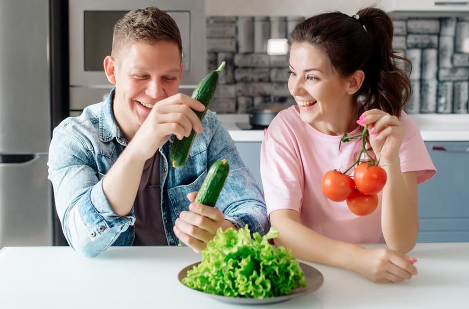 Lachendes Veganer-Paar mit Gemüse (Symbolbild)