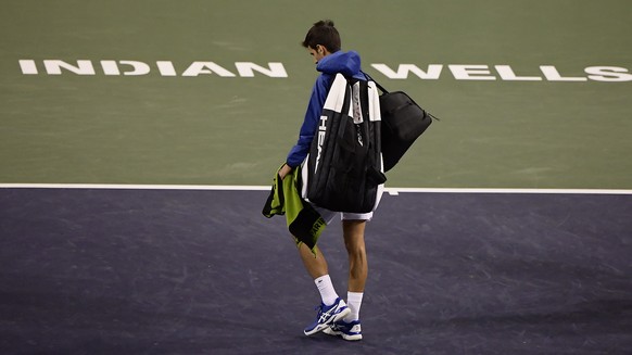 FILE - In this Monday, March 11, 2019, file photo, Novak Djokovic, of Serbia, walks off the court during a rain break in his match against Philipp Kohlschreiber, of Germany, at the BNP Paribas Open te ...
