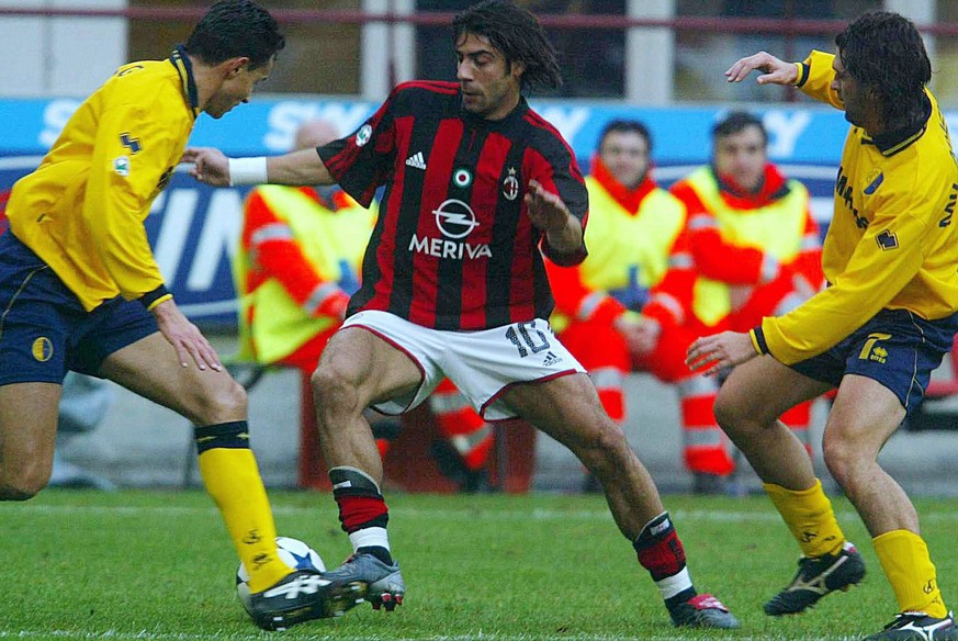 Portuguese midfielder Manuel Rui Costa (C) of AC Milan is challenged by two unidentified players of Modena during their Italian Serie A soccer match in Milan&#039; San Siro-Giuseppe Meazza stadium, Su ...