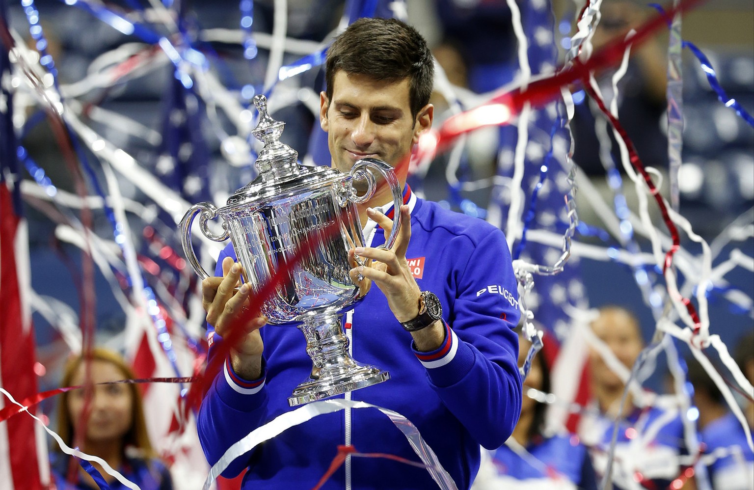 Novak Djokovic, of Serbia, holds up the championship trophy after defeating Roger Federer, of Switzerland, during the men&#039;s championship match of the U.S. Open tennis tournament, Sunday, Sept. 13 ...
