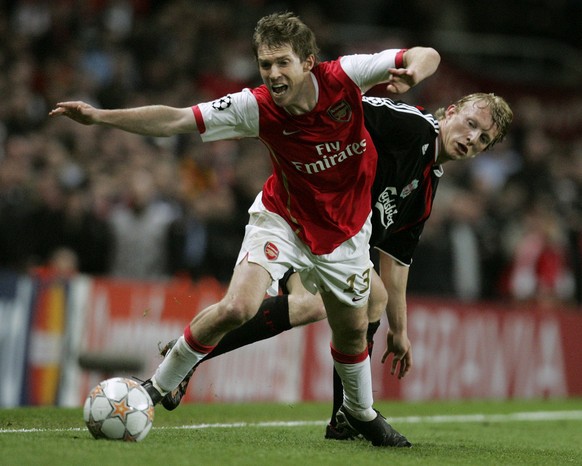 Arsenal&#039;s Alexander Hleb, front, gets the ball away from Liverpool&#039;s Dirk Kuyt, back, during their Champions League quarterfinal first leg soccer match at Arsenal&#039;s Emirates Stadium in  ...
