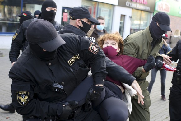 Police officers detain a woman during an opposition rally to protest the official presidential election results in Minsk, Belarus, Saturday, Sept. 19, 2020. Daily protests calling for the authoritaria ...