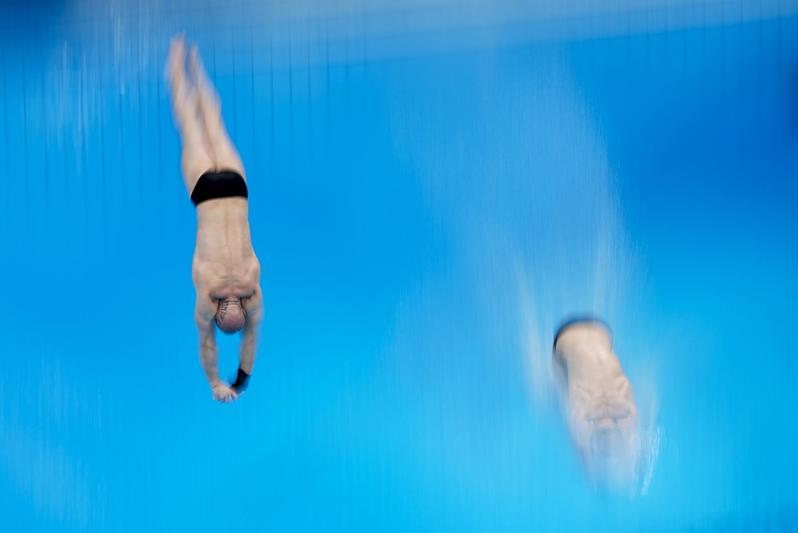 Russian Olympic Committee&#039;s Evgenii Kuznetsov and Nikita Shleikher compete during men&#039;s synchronised 3-meter springboard at the 2020 Summer Olympics, Monday, July 26, 2021, in Tokyo, Japan.  ...