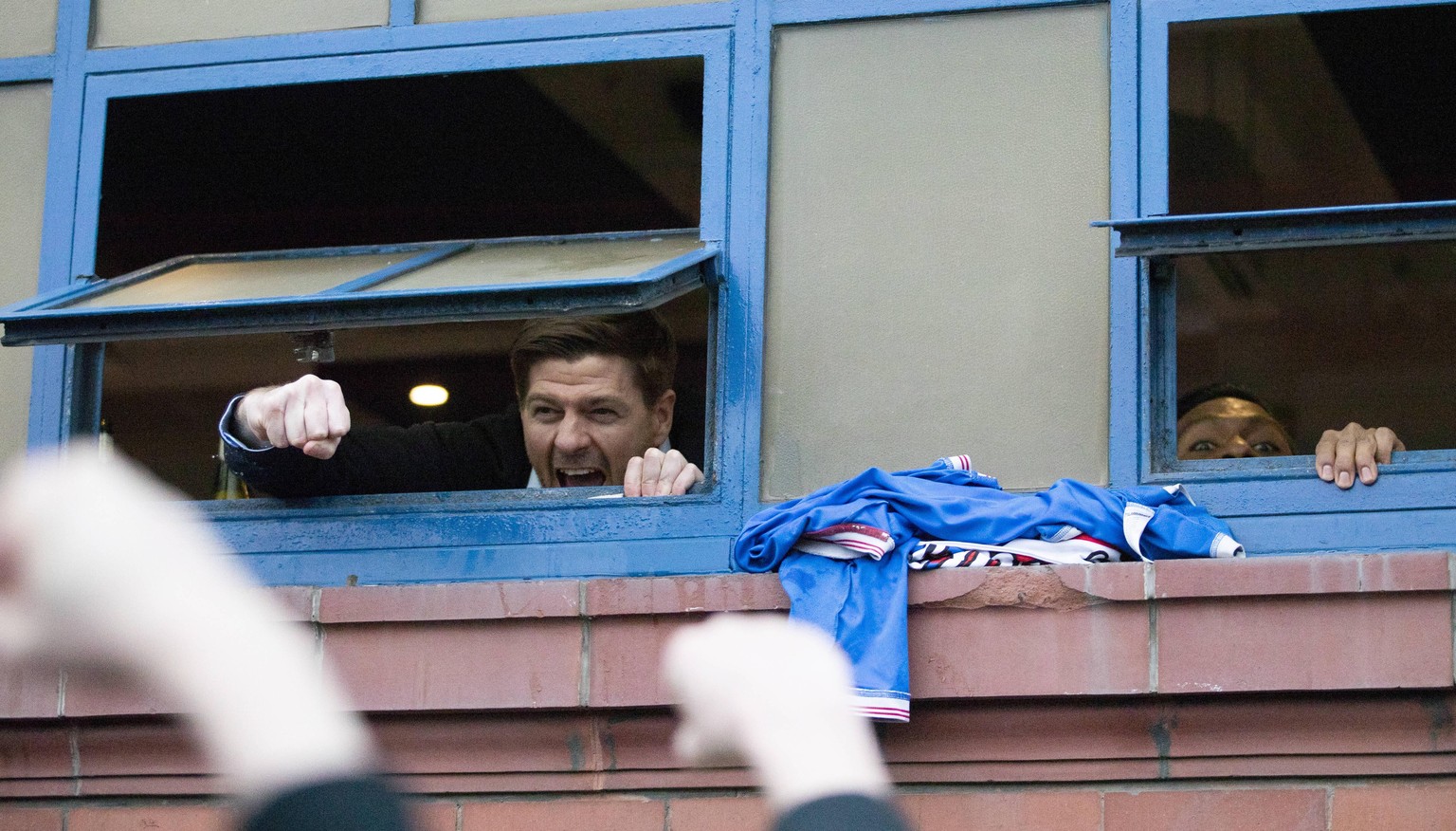 Rangers v St Mirren - Scottish Premiership - Ibrox Stadium Rangers manager Steven Gerrard and Alfredo Morelos right hang out the window of the dressing room to cheer with fans gathered outside the sta ...