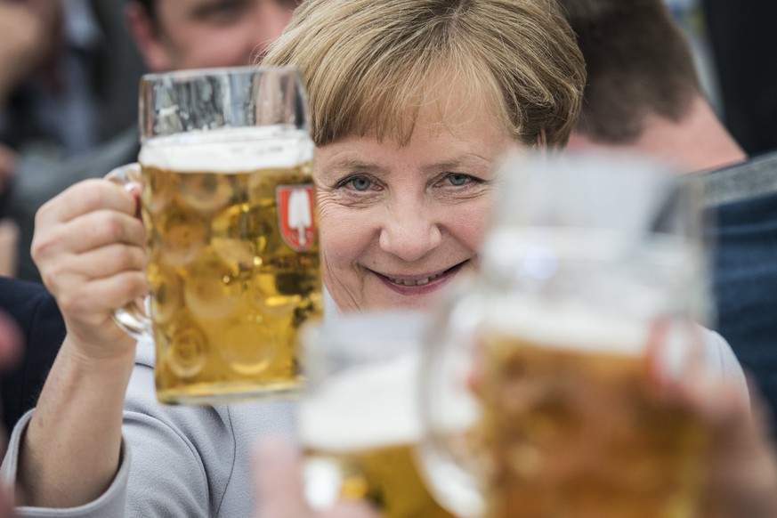 epa05995406 Germany&#039;s Christian Democratic Union (CDU) party chairwoman and German Chancellor Angela Merkel toasts with a beer during an election campaign event of the German Christian Social Uni ...