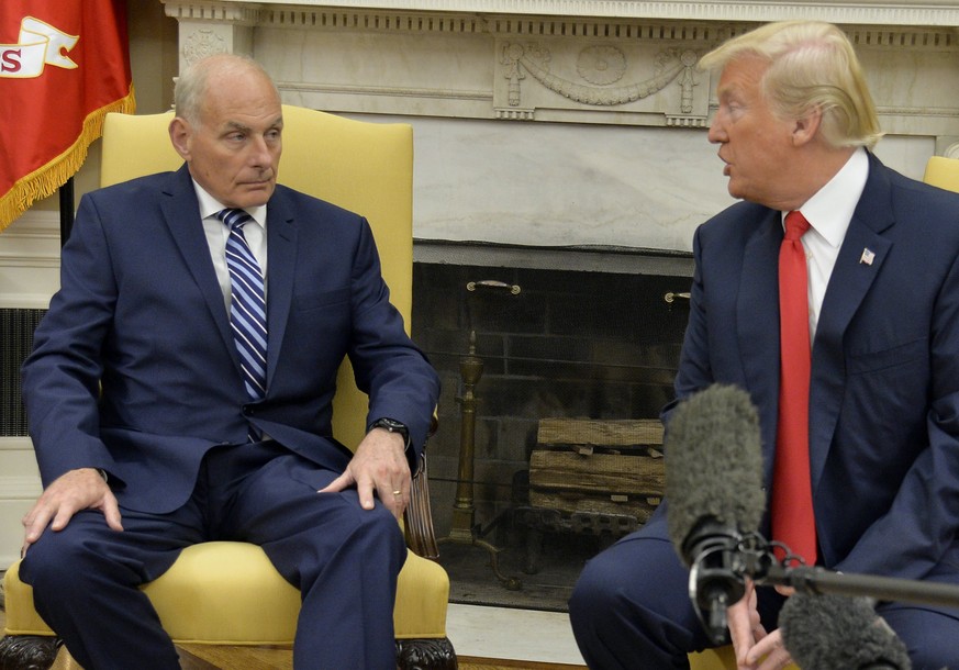 epa06118853 US President Donald J. Trump (R) speaks to the press contingent as he looks towards the new White House Chief of Staff John Kelly (L) was sworn in to his new position, at the White House,  ...