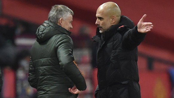 epa08880268 Manchester United&#039;s manager Ole Gunnar Solskjaer (L) and Manchester City manager Pep Guardiola (R) talk after the English Premier League soccer match between Manchester United and Man ...