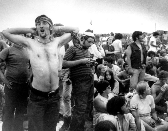 FILE - In this Aug. 16, 1969 file photo music fans relax during a break in the entertainment at the Woodstock Music and Arts Fair in Bethel, N.Y. It was great spot for peaceful vibes, but miserable fo ...