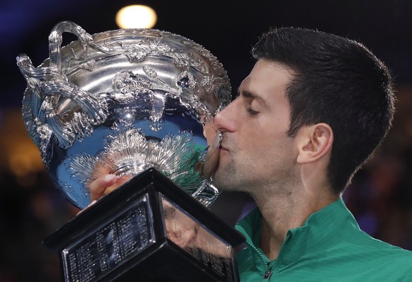 Serbia&#039;s Novak Djokovic kisses the Norman Brookes Challenge Cup after defeating Austria&#039;s Dominic Thiem in the men&#039;s singles final of the Australian Open tennis championship in Melbourn ...