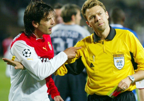 Swiss referee Urs Meier, center, argues with Monaco&#039;s striker fernando Morientes, left, as Monaco&#039;s captain Ludovic Giuly looks on, after Meier gave Monaco&#039;s Andreas Zikos a red card du ...