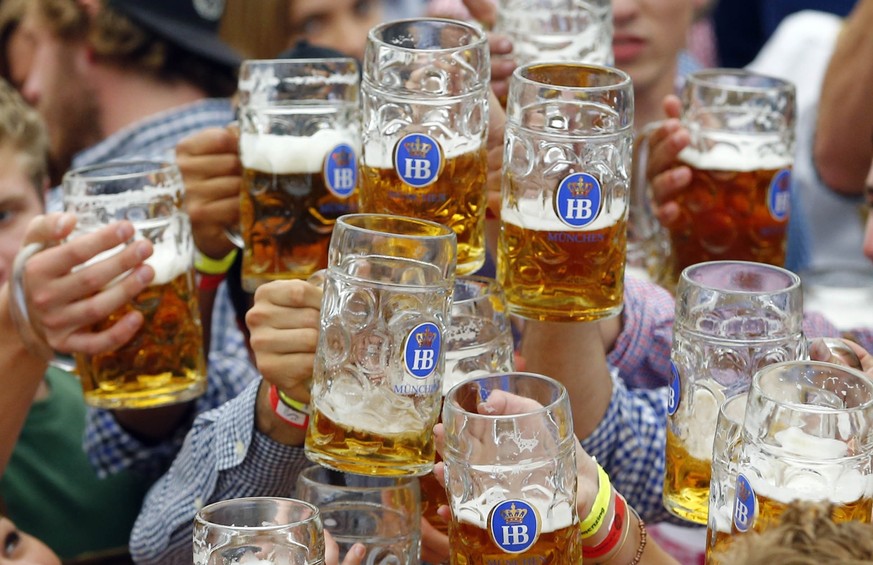 FILE - In this Sept. 19, 2015 file photo, people celebrate the opening of the 182nd Oktoberfest beer festival in Munich, sGermany. Munich’s city council has voted down an attempt to cap foaming beer p ...