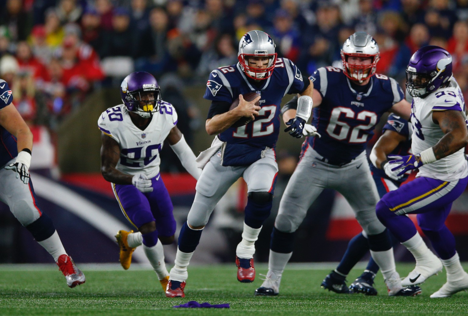 epa07204955 New England Patriots quarterback Tom Brady (C) runs with the ball against the Minnesota Vikings during the first quarter at Gillette Stadium in Foxboro,, Massachusetts, USA, 02 December 20 ...
