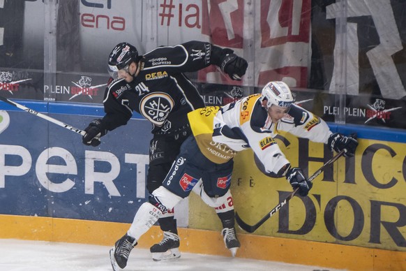 From left, LuganoÄôs player Jani Lajunen and Ambri&#039;s player Misha Moor, during the preliminary round game of National League A (NLA) Swiss Championship 2019/20 between HC Lugano and HC Ambri Pio ...