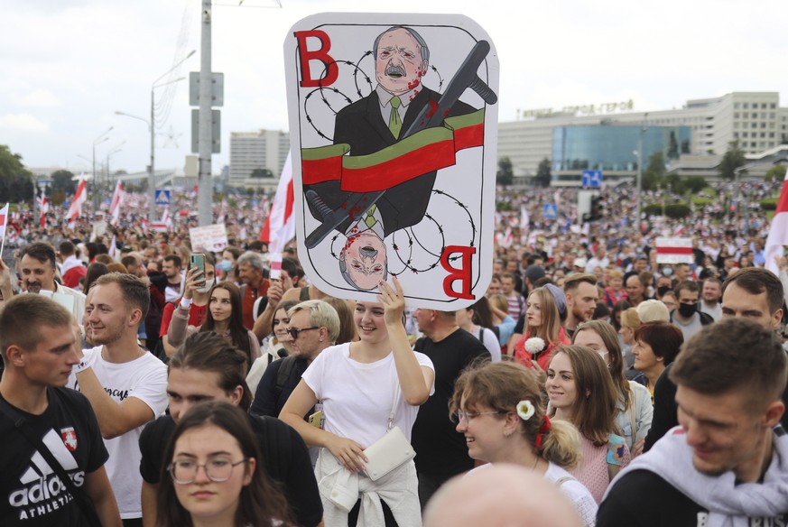 A woman holds a caricature of Belarus President Alexander Lukashenko during an opposition rally to protest the official presidential election results in Minsk, Belarus, Sunday, Sept. 6, 2020. Sunday&# ...