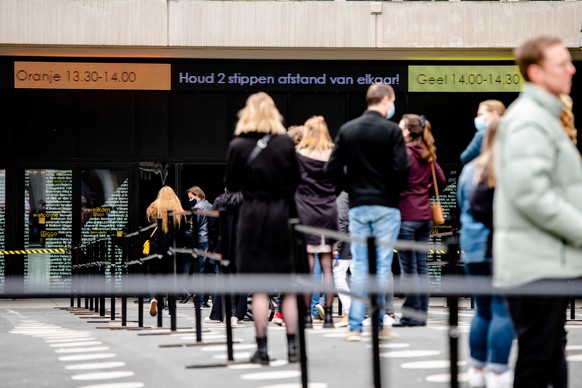 epa09056720 Visitors queue prior to a dance event in Ziggo Dome in Amsterdam, The Netherlands, 06 March 2021. During a series of events, Fieldlab Events Co. investigates how large groups of people can ...