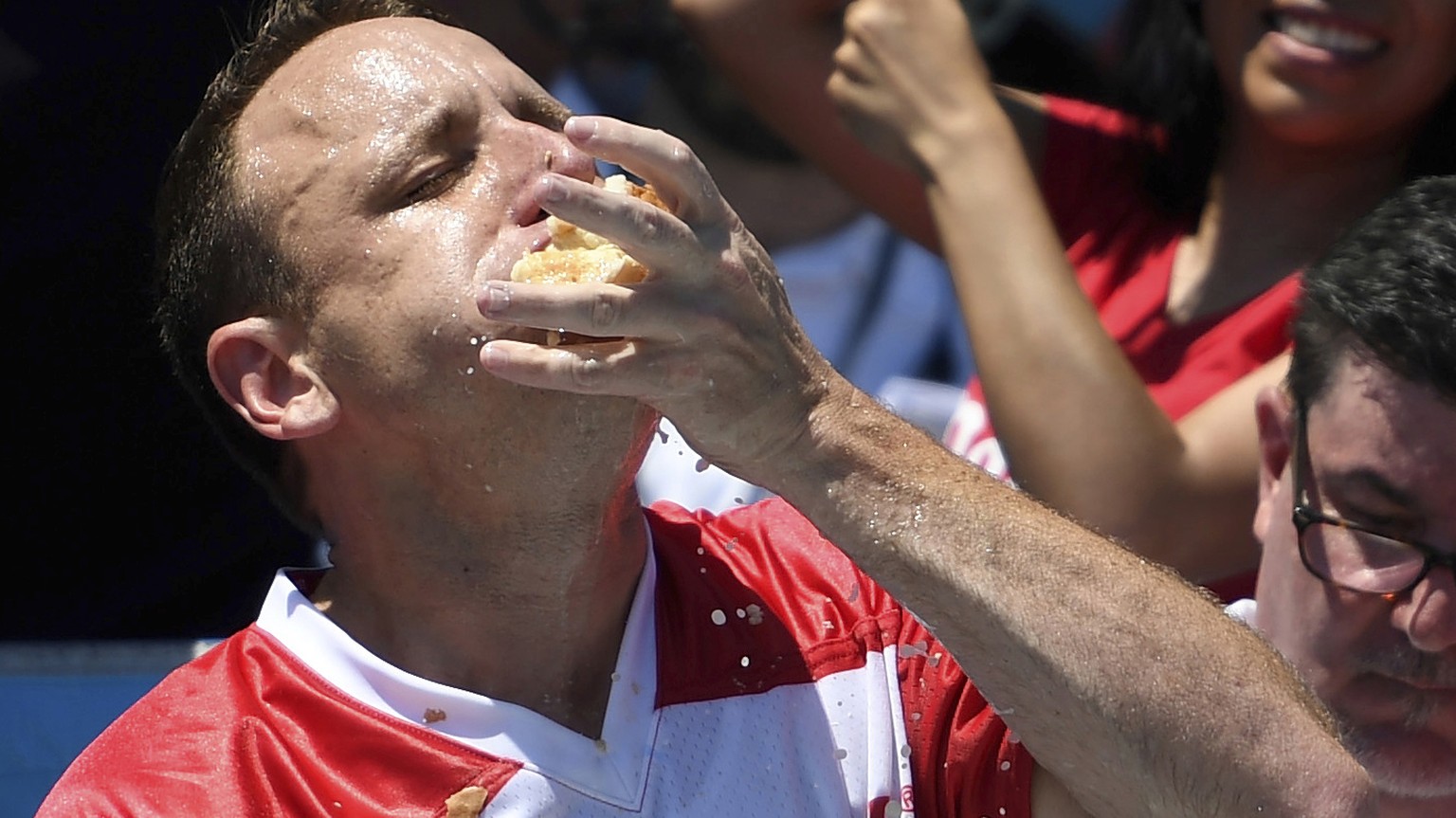 Joey Chestnut stuffs his mouth with hot dogs during the men&#039;s competition of Nathan&#039;s Famous July Fourth hot dog eating contest, Thursday, July 4, 2019, in New York&#039;s Coney Island. (AP  ...