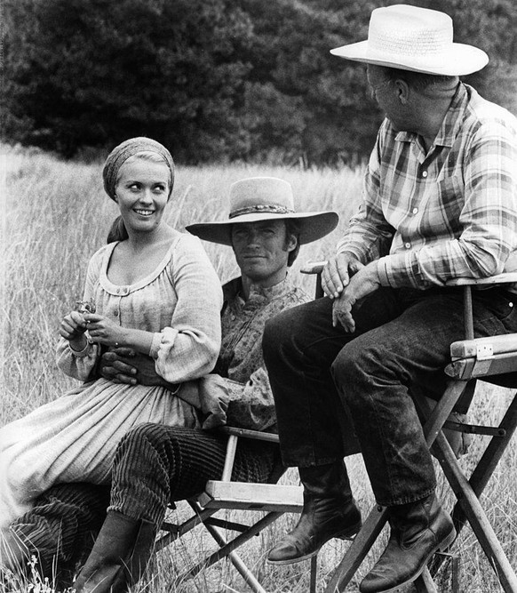Jean Seberg, Clint Eastwood, and director Joshua Logan sitting in between scenes from the film &#039;Paint Your Wagon&#039;, 1969. (Photo by Paramount/Getty Images)