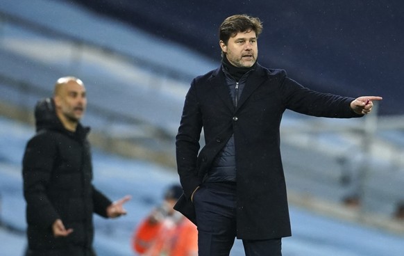 PSG&#039;s head coach Mauricio Pochettino, right, and Manchester City&#039;s head coach Pep Guardiola gesture during the Champions League semifinal second leg soccer match between Manchester City and  ...