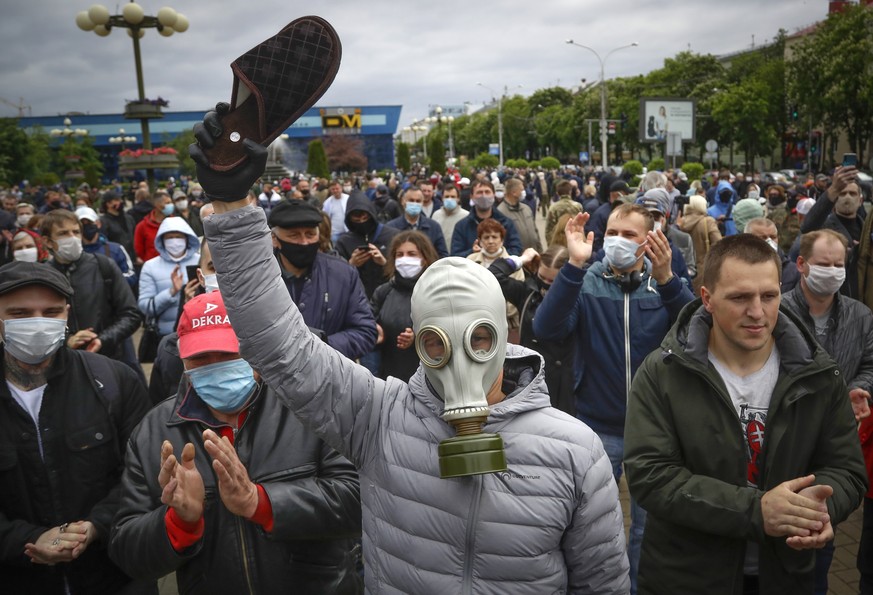 A man, wearing a mask to protect against coronavirus, attends a rally to support for potential presidential candidates in the upcoming presidential elections in Minsk, Belarus, Sunday, May 31, 2020. A ...