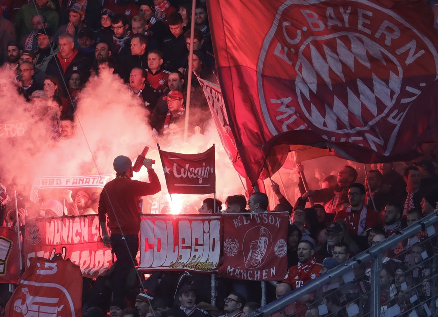 Bayern&#039;s fans light flares during a German Bundesliga soccer match between TSG 1899 Hoffenheim and Bayern Munich in Sinsheim, Germany, Saturday, Feb. 29, 2020. (AP Photo/Michael Probst)