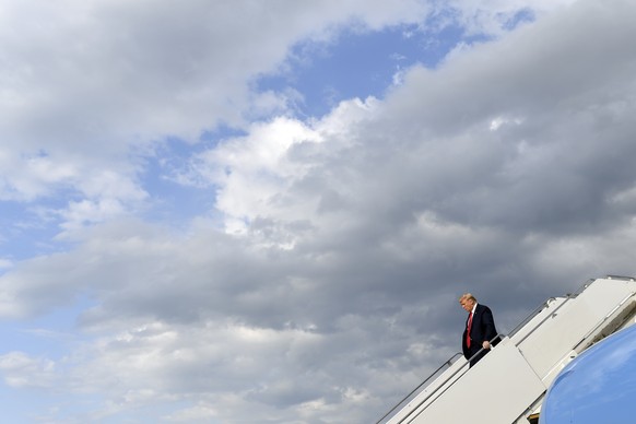 President Donald Trump walks down the steps of Air Force One at Morristown Municipal Airport in Morristown, N.J., Friday, Aug. 9, 2019. Trump will be vacationing at his golf club in New Jersey for a w ...