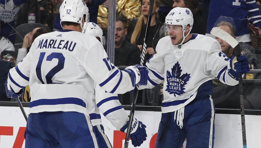 Toronto Maple Leafs center Auston Matthews, right, celebrates after scoring against the Vegas Golden Knights during the third period of an NHL hockey game Thursday, Feb. 14, 2019, in Las Vegas. (AP Ph ...