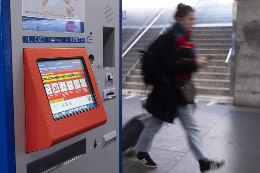 Une personne marche a cote d&#039;un distributeur automatique de billet a la Gare CFF de Lausanne lors de la pandemie du virus Coronavirus, (Covid-19) ce lundi 16 mars 2020 a Lausanne. (KEYSTONE/Leand ...