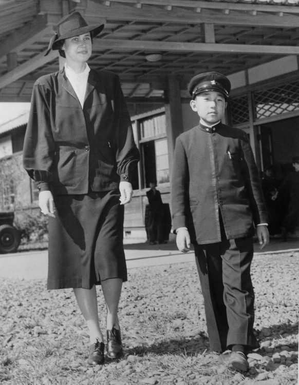 (Original Caption) Crown Prince Likes New Teacher from America. Tokyo, Japan: Japanese Crown Prince Akihito strolls before the Peers School in Tokyo with his new English Tutor, Mrs. Elizabeth Gray Vin ...