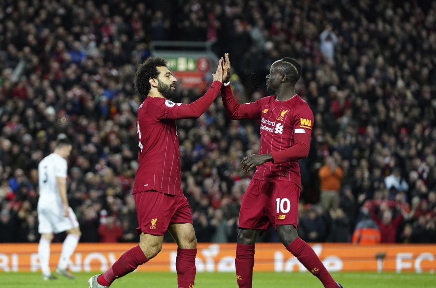 Liverpool&#039;s Mohamed Salah, front left, celebrates with Liverpool&#039;s Sadio Mane after scoring his side&#039;s opening goal during the English Premier League soccer match between Liverpool and  ...